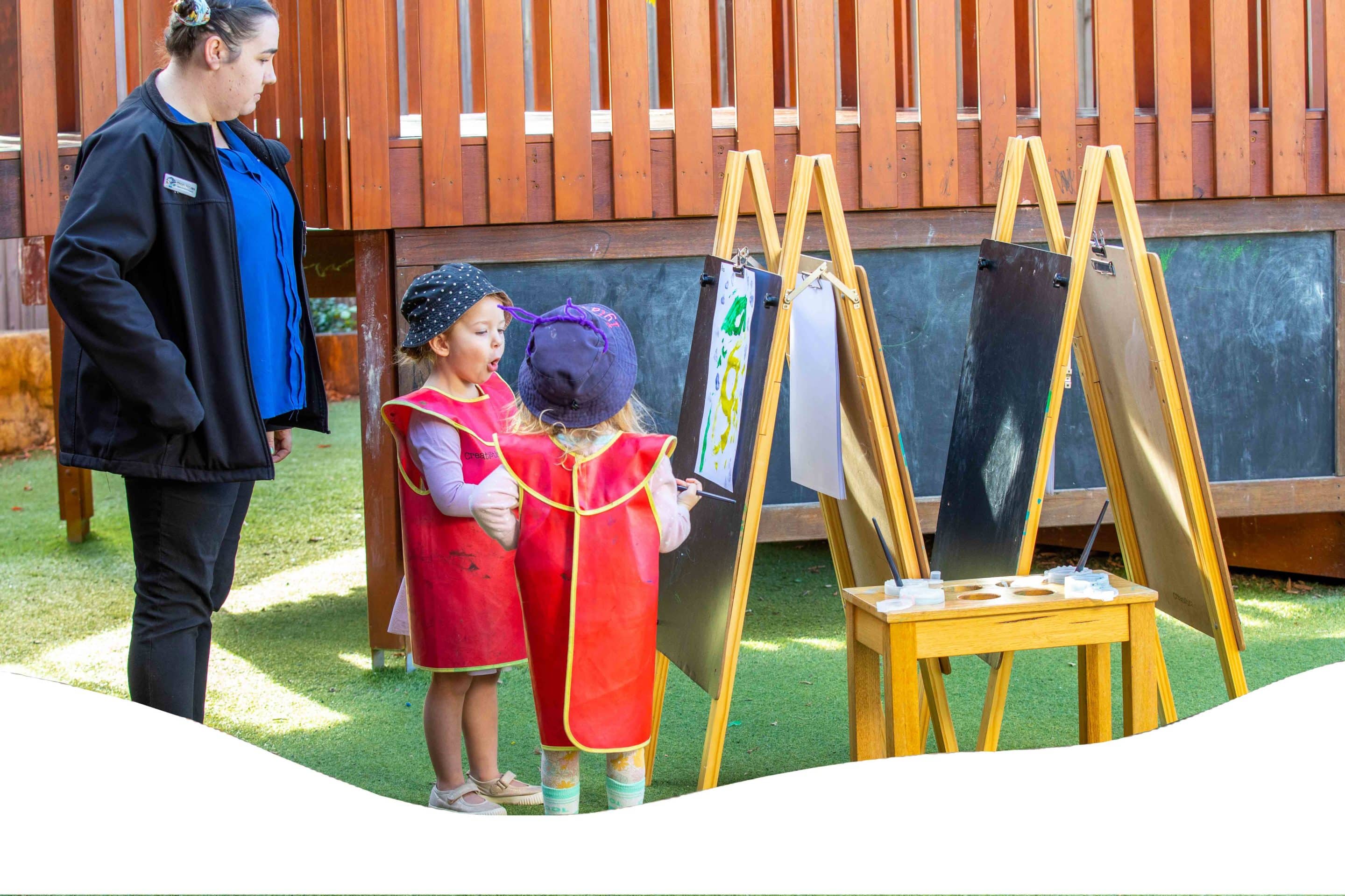 A Teacher And Two Kids Drawing — Early Learning Centre Maudsland,QLD