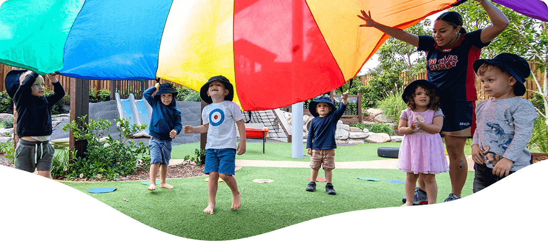 Children Playing at The Playground with Educator — Early Learning Centre in Ashmore, QLD