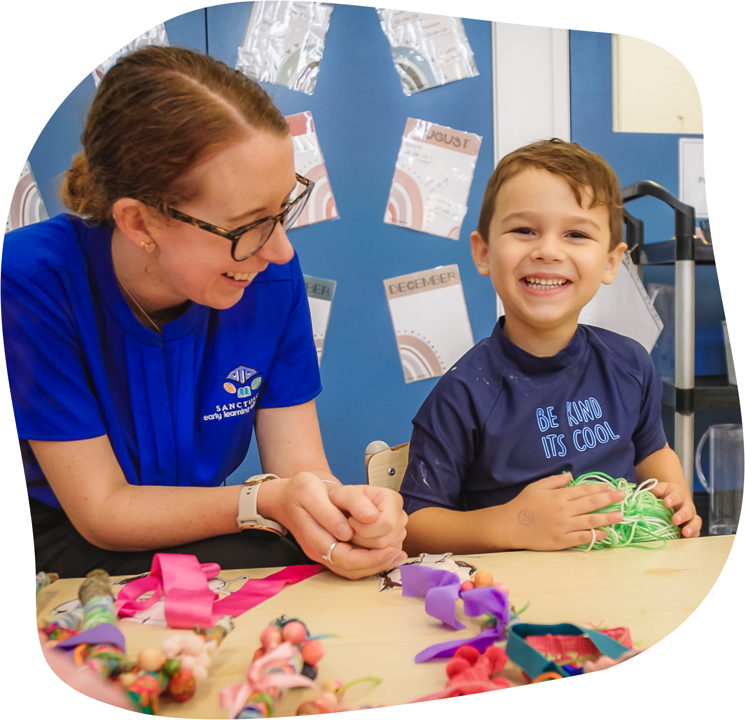 Childcare teacher playing with toys in buderim