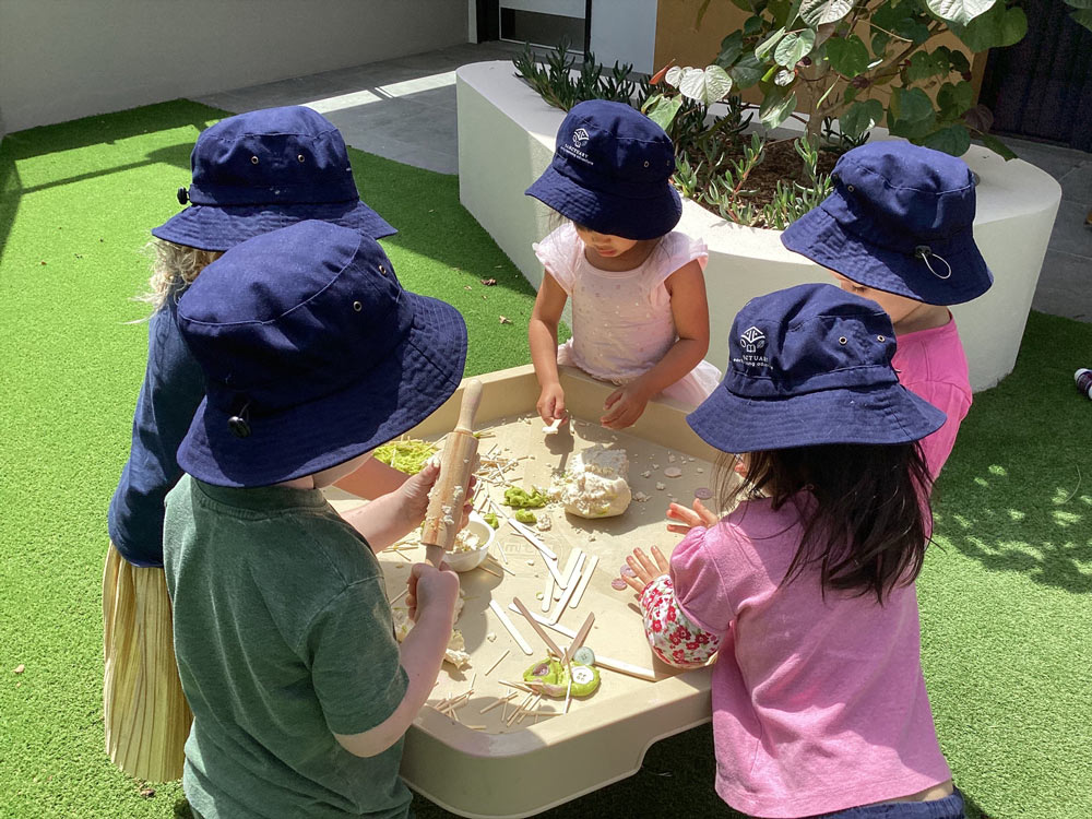 A Group Of Children Engaged In Sand Play