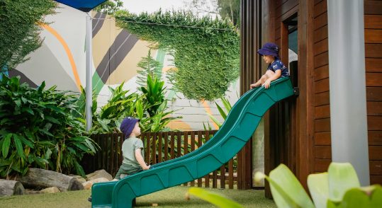 Children playing on a slide — Early Learning Centres Near Me in Ashmore, QLD