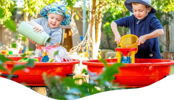 Two Kids Helping The Garden — Early Learning Centre Maudsland,QLD