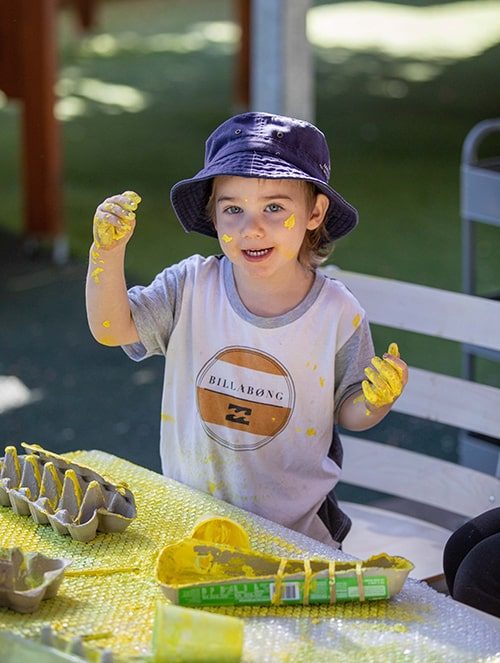 Kid enjoying your paint — Early Learning Centre in Buderim, QLD