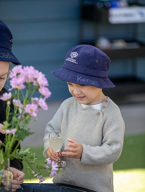 Two kids enjoying flowers — Early Learning Centre in Buderim, QLD