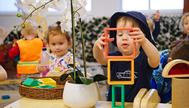 Happy Child Presenting a Wooden Block — Early Learning Centre Maudsland,QLD