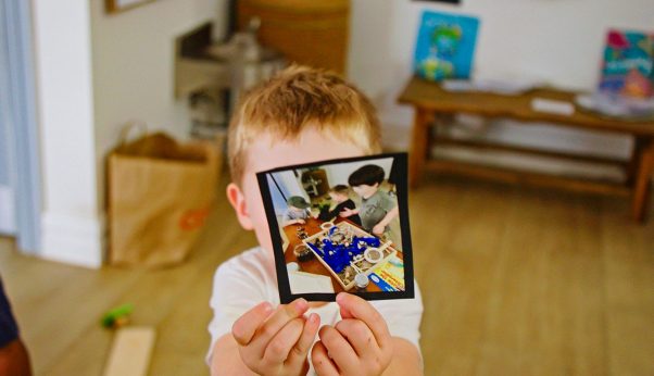 Young Boy Showing a Picture — Early Learning Centre Maudsland,QLD