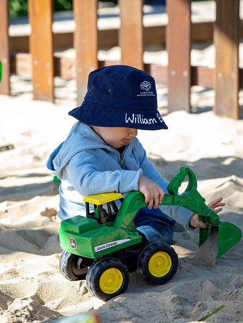 Boy playing with his toy bulldozer — Early Learning Centre in Maudsland, QLD