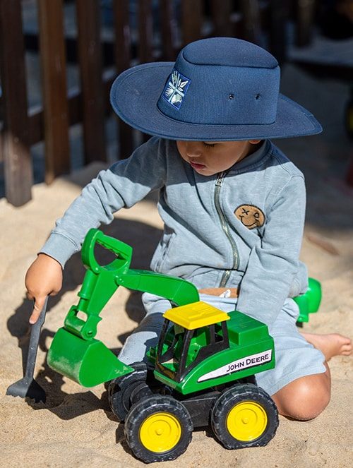 Kid with cowboy hat playing with his toy — Early Learning Centre in Maudsland, QLD
