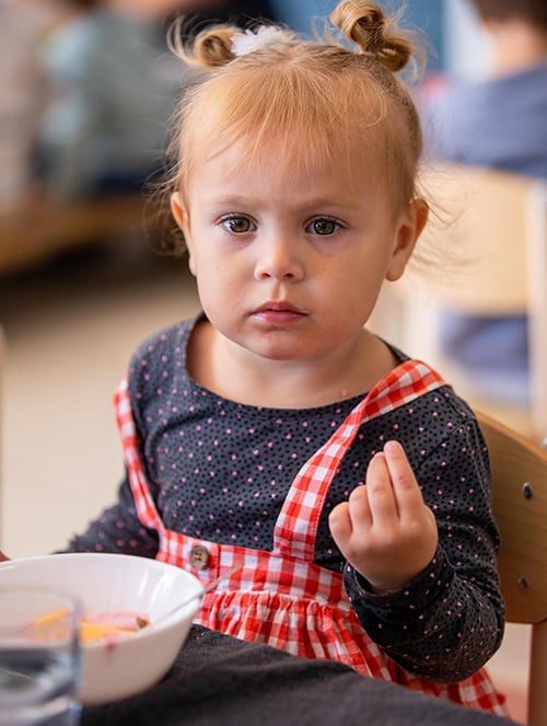 Baby girl holding out her fingers — Early Learning Centre in Maudsland, QLD