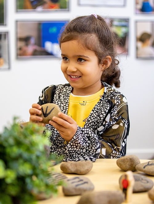 Girl holding a stone — Early Learning Centre in Maudsland, QLD