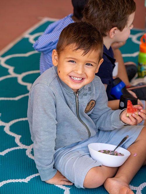 Happy boy with a bowl of food — Early Learning Centre in Maudsland, QLD